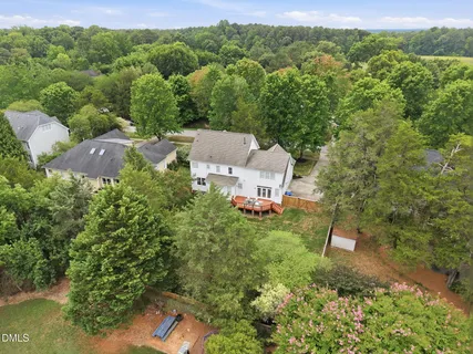 an aerial view of a houses with outdoor space and trees