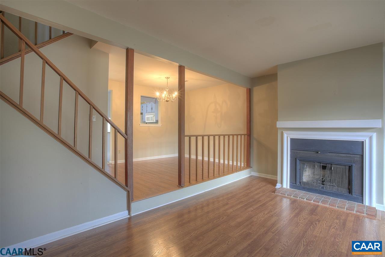 1619 Cool Spring Road Charlottesville, VA 22901 - Photo 5 of 14 a view of an empty room with wooden floor a fireplace and a window