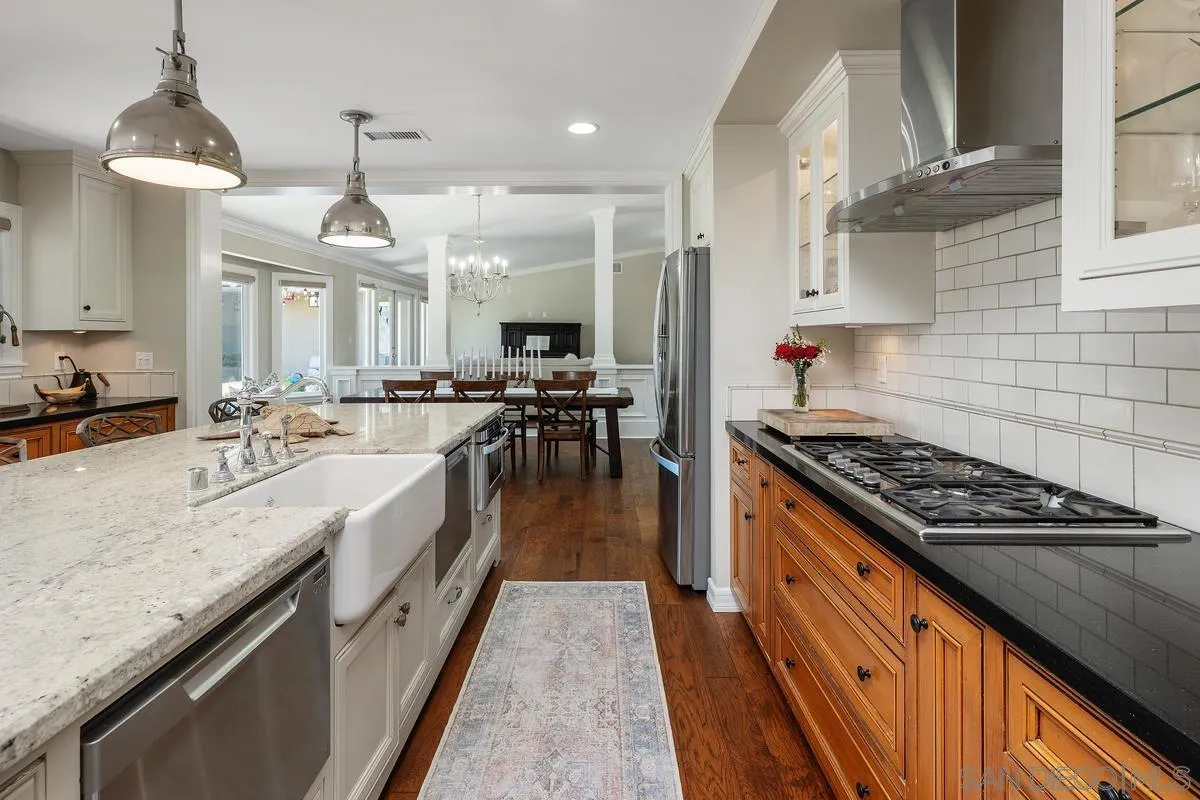 13627 Poway Springs Road Poway, CA 92064 - Photo 12 of 60 a large kitchen with stainless steel appliances granite countertop a stove and a large countertops with cabinets