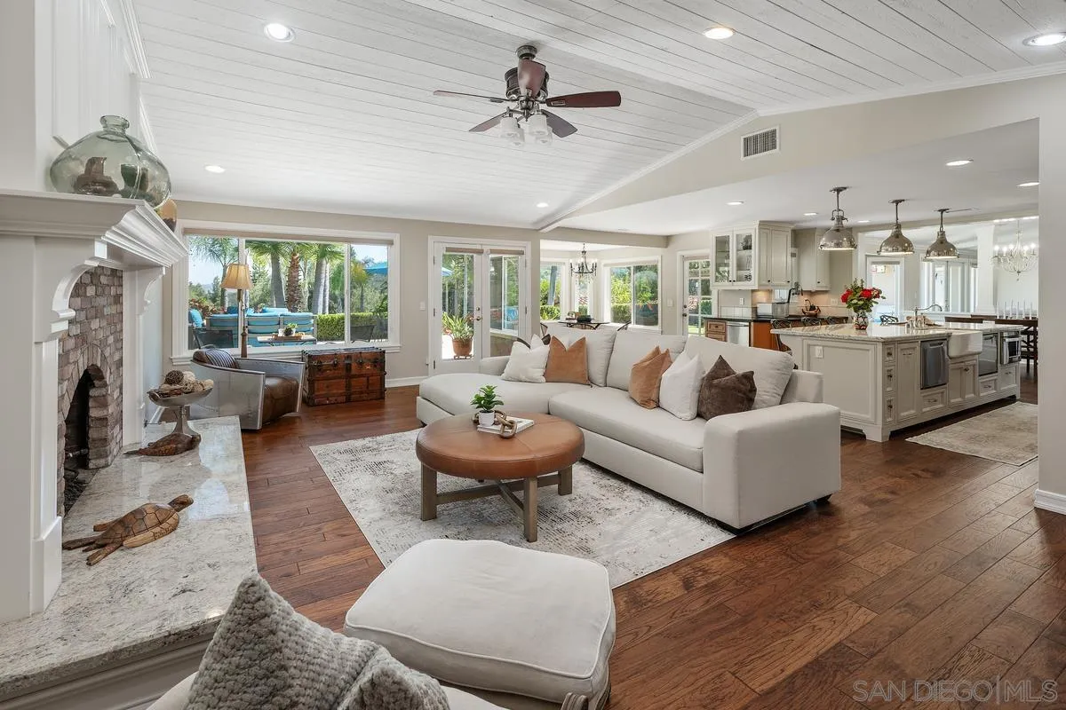 13627 Poway Springs Road Poway, CA 92064 - Photo 16 of 60 a living room with fireplace furniture and a chandelier