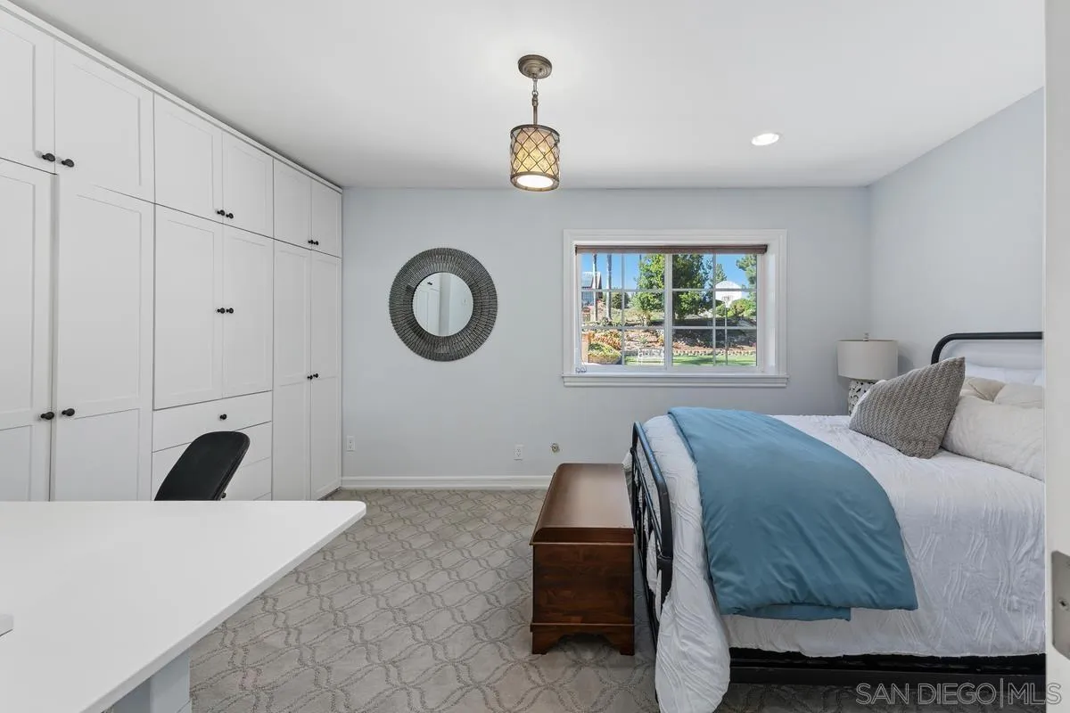 13627 Poway Springs Road Poway, CA 92064 - Photo 19 of 60 a bedroom with a bed and a chandelier