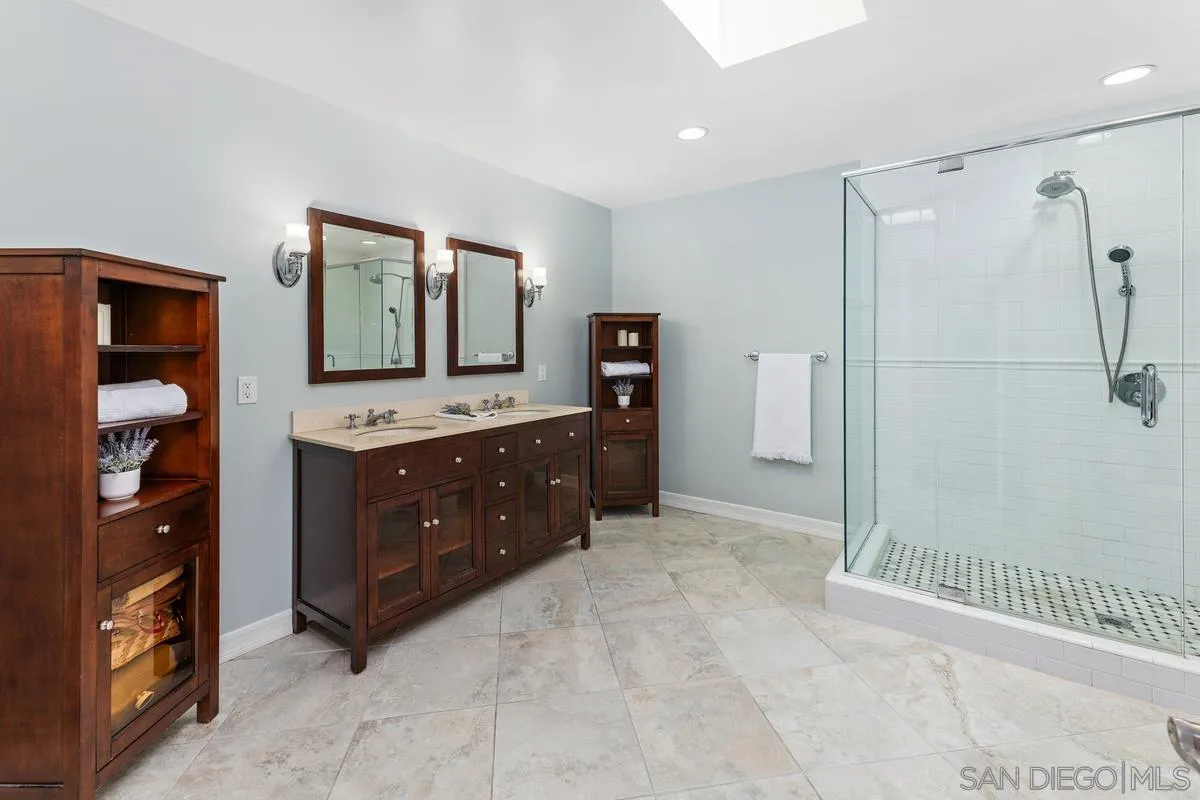 13627 Poway Springs Road Poway, CA 92064 - Photo 22 of 60 a bathroom with a double vanity sink toilet and shower