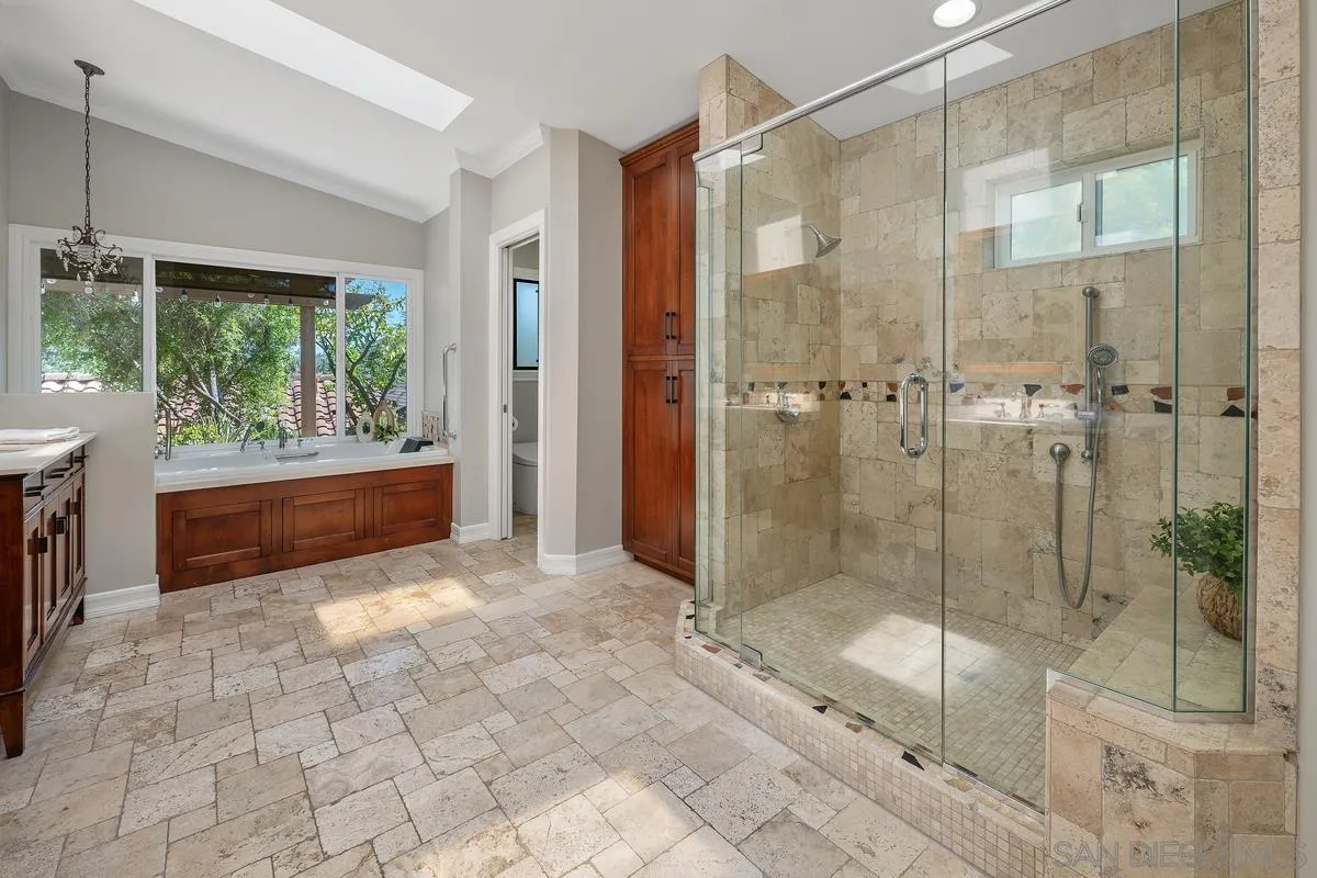 13627 Poway Springs Road Poway, CA 92064 - Photo 26 of 60 a bathroom with a glass shower door and a glass door