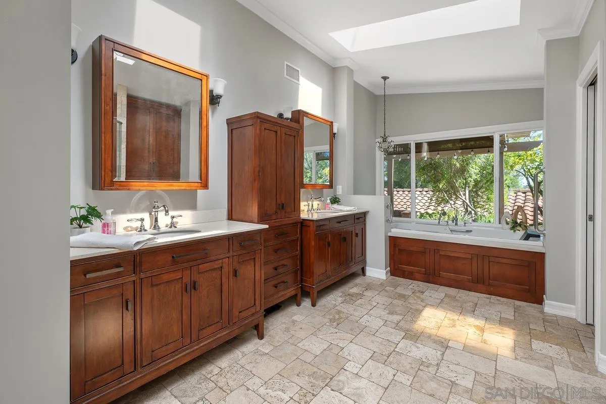 13627 Poway Springs Road Poway, CA 92064 - Photo 27 of 60 a bathroom with a tub sink and mirror