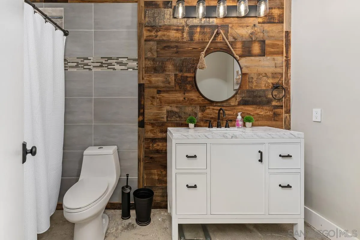13627 Poway Springs Road Poway, CA 92064 - Photo 47 of 60 a bathroom with a toilet sink and mirror
