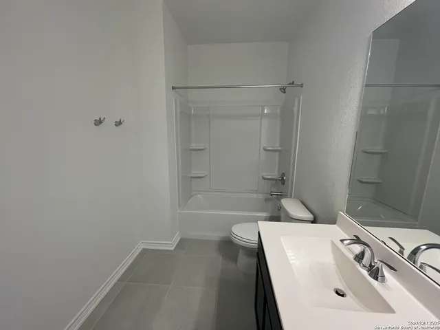 a bathroom with a double vanity sink mirror and toilet