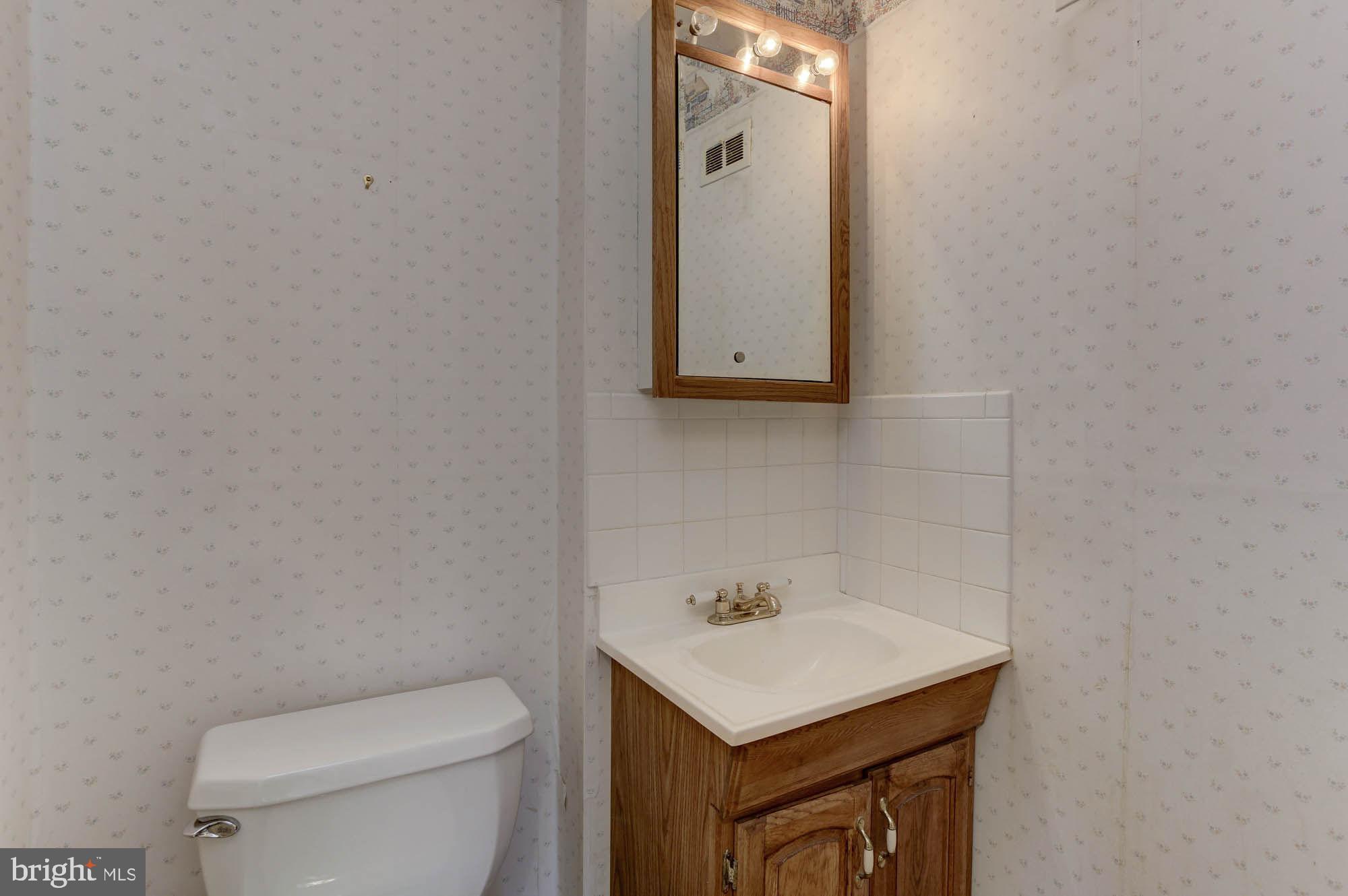6104 Goodman Road Laurel, MD 20707 - Photo 36 of 42 Powder room off family room & next to bedroom 5