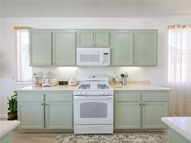 a kitchen with a cabinets sink and stove top oven