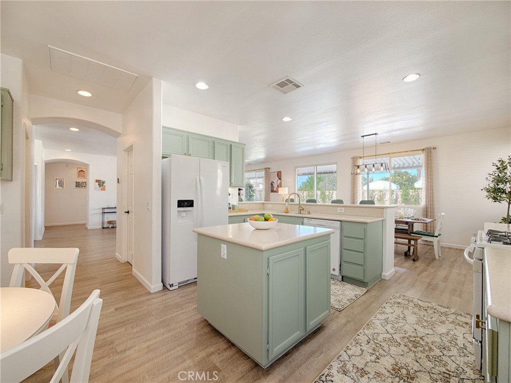 80718 Mountain Mesa Drive Indio, CA 92201 - Photo 12 of 47 a kitchen that has a lot of cabinets a sink and a refrigerator in it