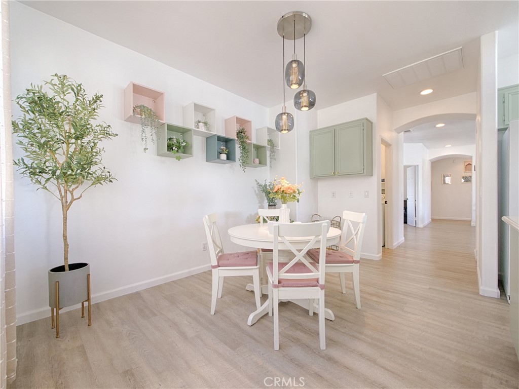 80718 Mountain Mesa Drive Indio, CA 92201 - Photo 14 of 47 a view of a dining room with furniture and wooden floor