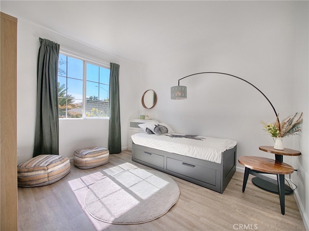 80718 Mountain Mesa Drive Indio, CA 92201 - Photo 26 of 47 a bedroom with a bed and a potted plant