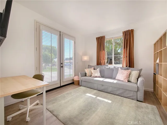a living room with furniture and a floor to ceiling window