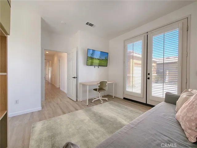 a bedroom with a bed and a television