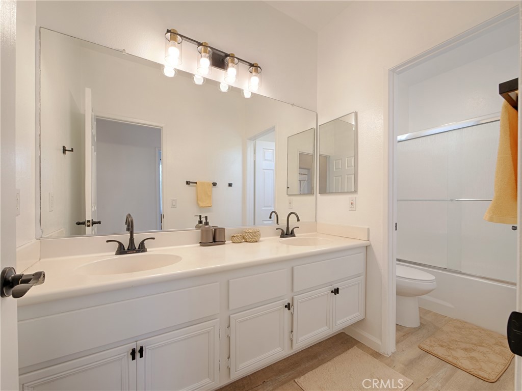 80718 Mountain Mesa Drive Indio, CA 92201 - Photo 30 of 47 a bathroom with a double vanity sink toilet and mirror
