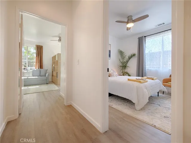 a bedroom with a bed and glass walk in closet