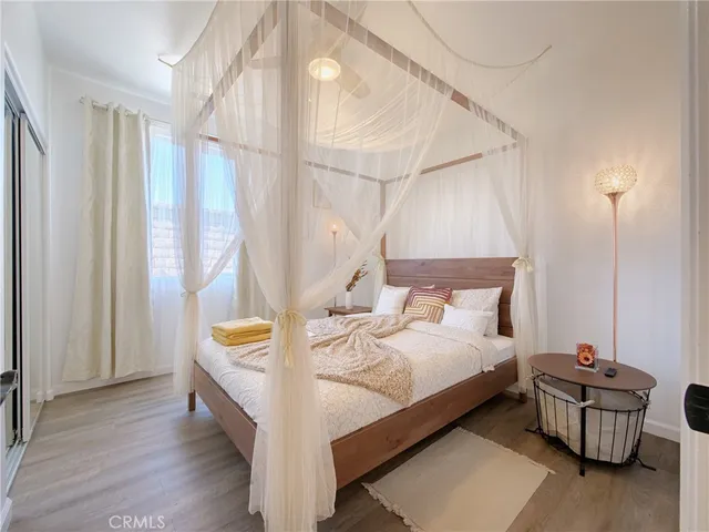 a bed room with a bed and a chair