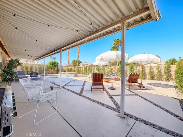 a outdoor space with lots of tables a large window and chairs