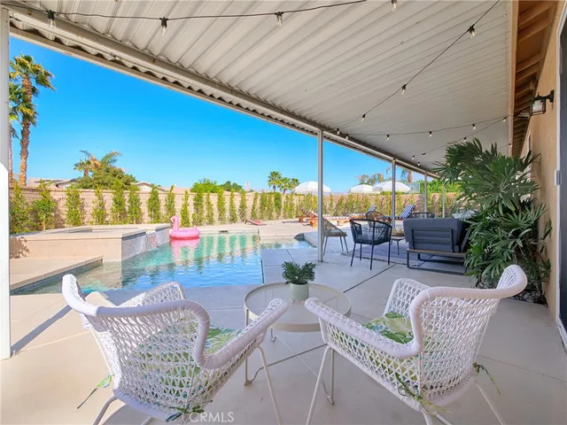a patio with a table and chairs