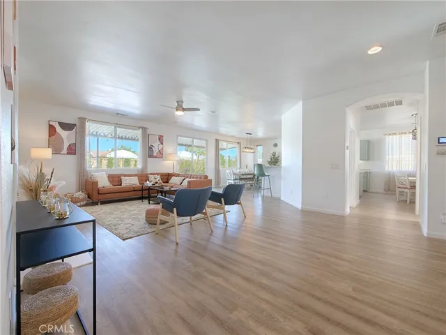 a living room with furniture and wooden floor