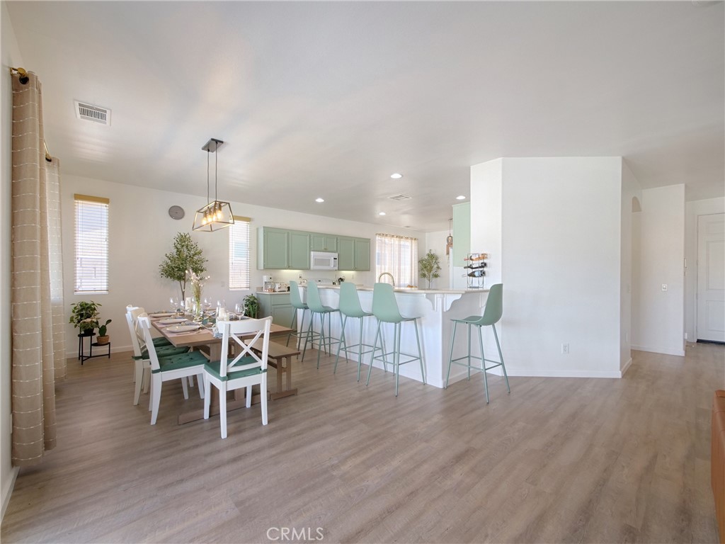 80718 Mountain Mesa Drive Indio, CA 92201 - Photo 8 of 47 a dining room with furniture a chandelier and wooden floor