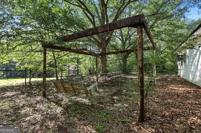 a view of a yard with large trees