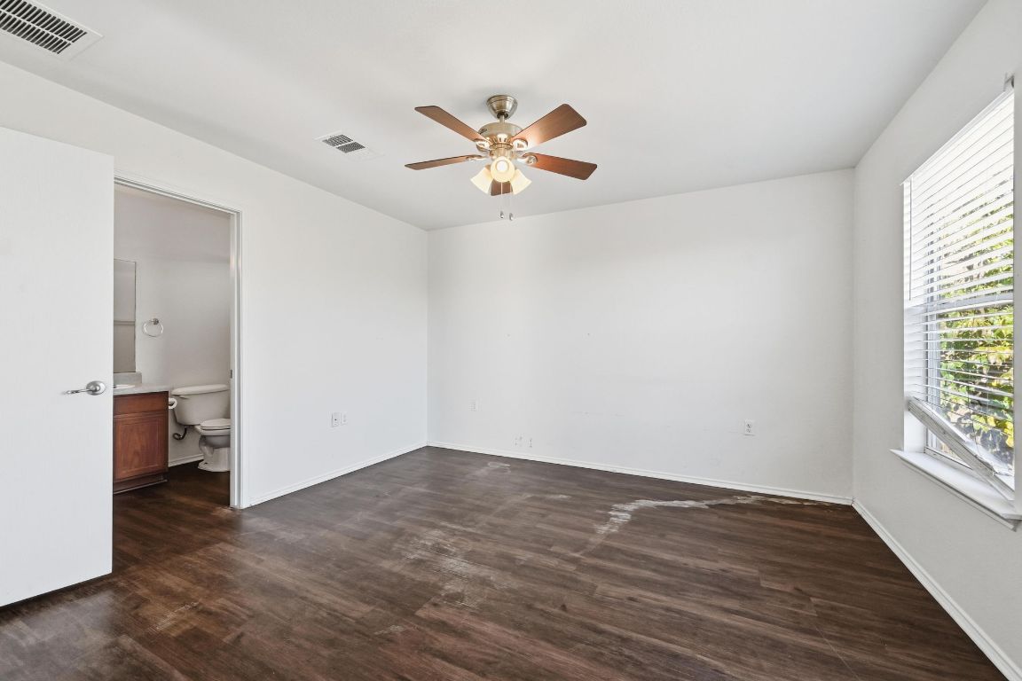 5813 Berryline Way Austin, TX 78724 - Photo 12 of 27 an empty room with wooden floor fan and windows
