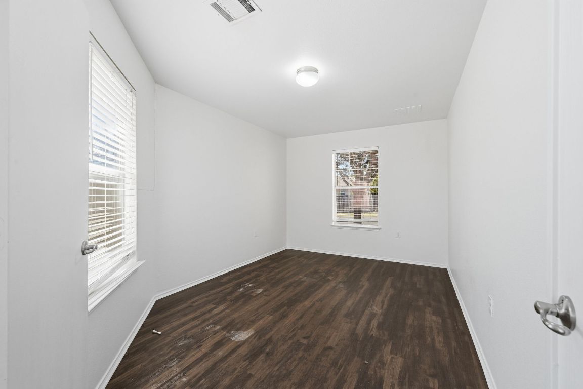 5813 Berryline Way Austin, TX 78724 - Photo 14 of 27 a view of room with window and hardwood floor
