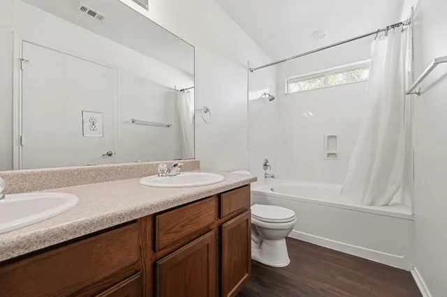 a bathroom with a granite countertop sink toilet a large mirror and shower