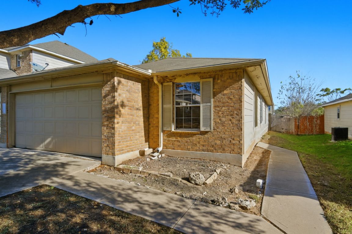 5813 Berryline Way Austin, TX 78724 - Photo 2 of 27 a front view of a house with a yard
