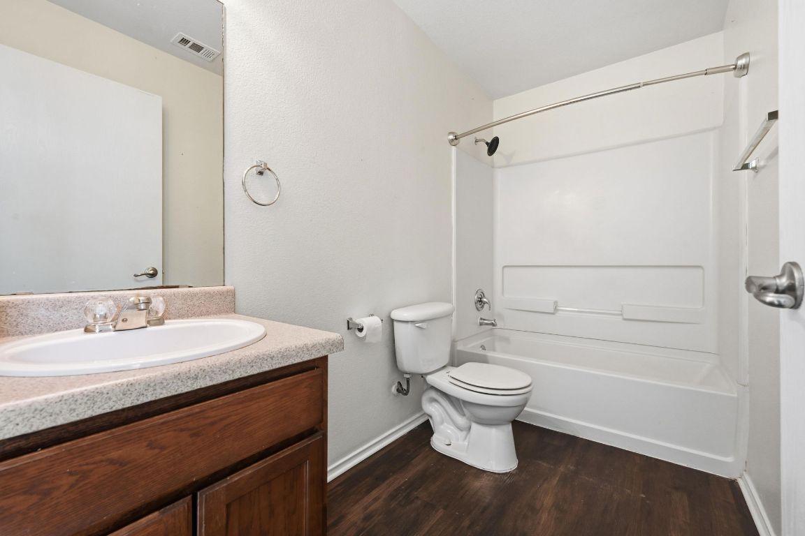 5813 Berryline Way Austin, TX 78724 - Photo 21 of 27 a bathroom with a sink a toilet and shower