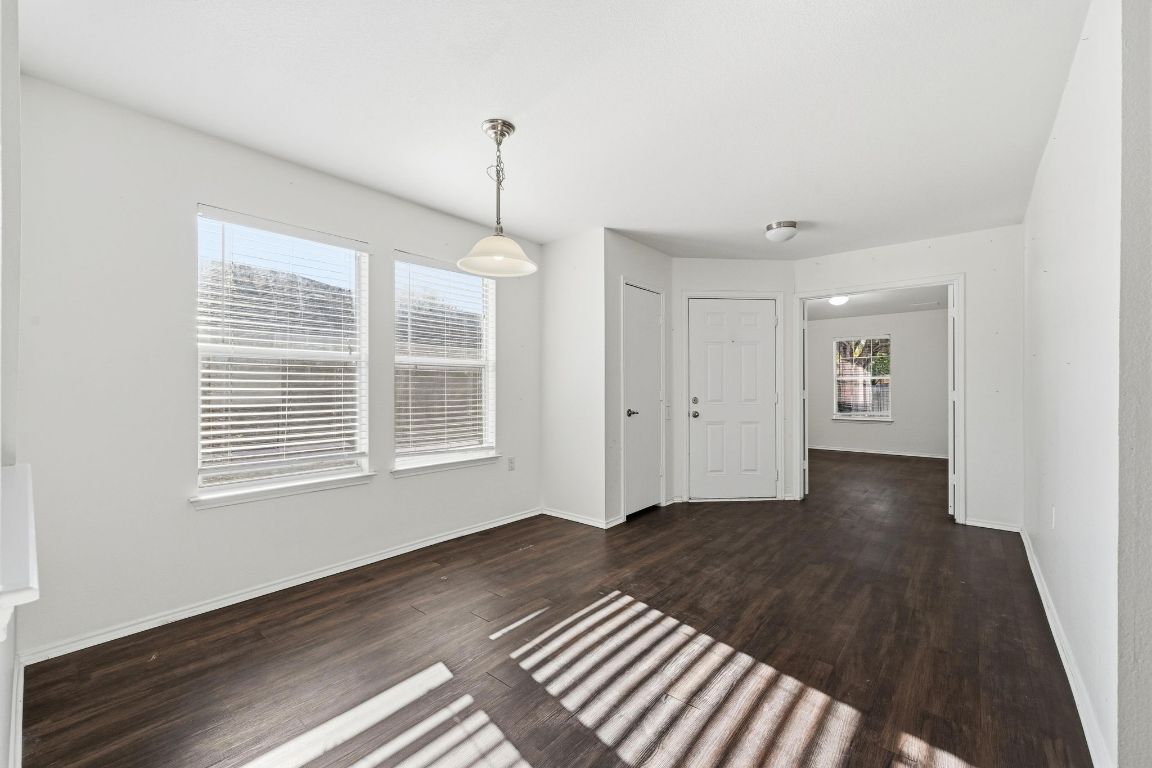 5813 Berryline Way Austin, TX 78724 - Photo 10 of 27 a view of an empty room with a window and wooden floor
