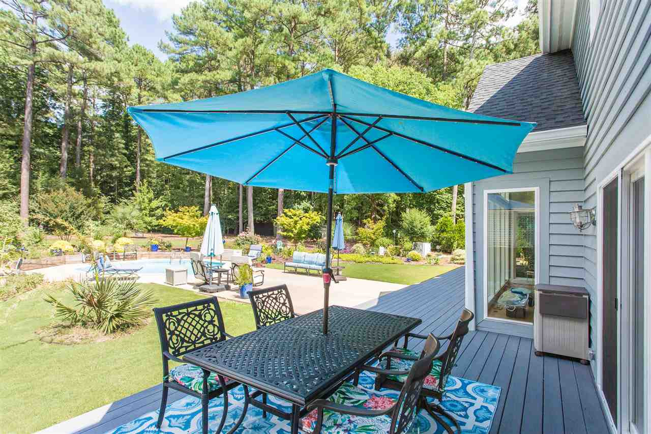 4409 Wood Valley Drive Raleigh, NC 27613 - Photo 28 of 30 All new decking has been installed and runs the entire back of the house. There is also a boardwalk along the back left of the property that provides a path from the back of the house to the backyard and shed. Deck Stretches along Back of House