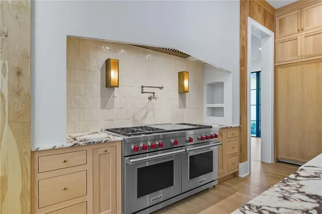 a spacious bathroom with a granite countertop sink mirror bathtub and shower