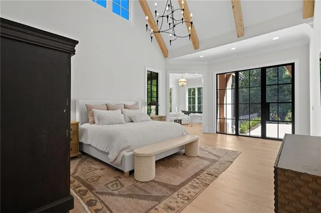 a bedroom with a bed and a chair with the bookshelf