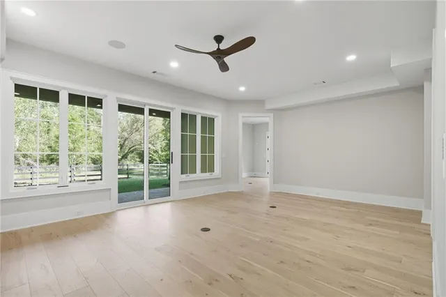 a view of an empty room with a fireplace and a window