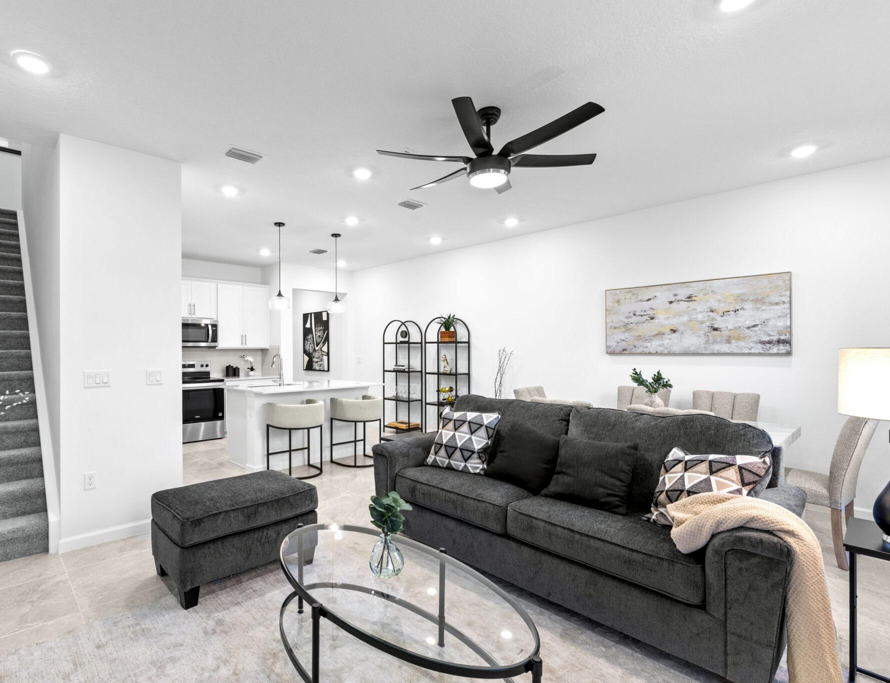 395 Southwest Sally Way Stuart, FL 34997 - Photo 4 of 12 a living room with furniture and a view of kitchen