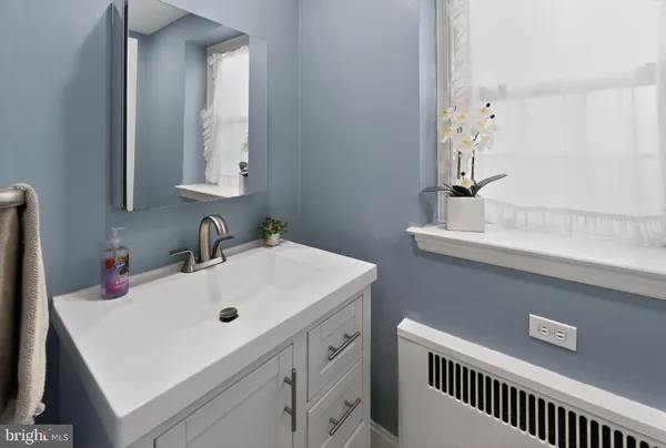 a bathroom with a sink and a mirror