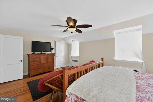a bedroom with furniture and a flat screen tv