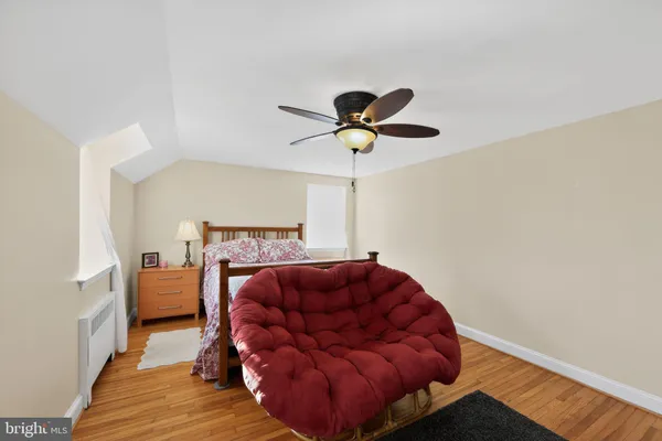 a living room with furniture a ceiling fan and a rug