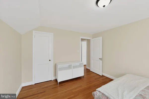 a view of a room with wooden floor and bathroom