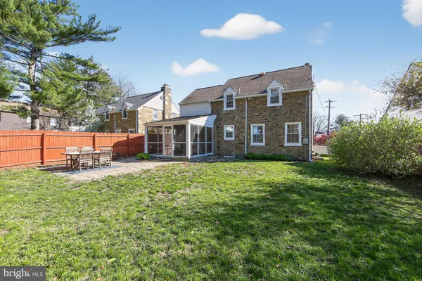 a view of a house with backyard porch and sitting area