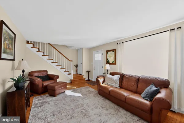 a living room with furniture or stairs and a wooden floor