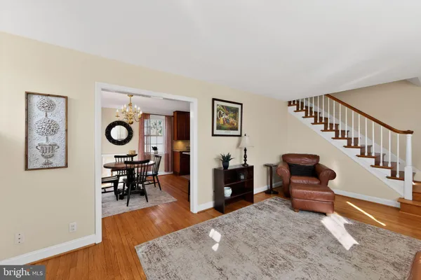 a living room with furniture and a dining table