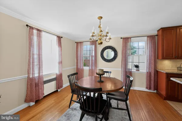 a view of a dining room with furniture and chandelier