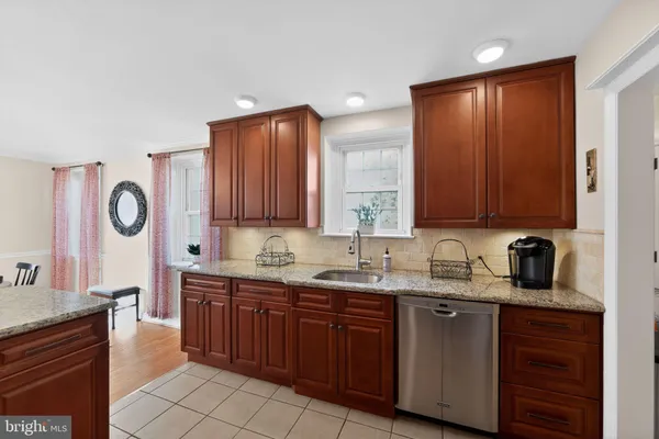 a kitchen with a sink and a stove top oven