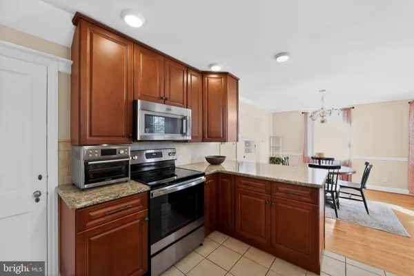 a kitchen with a sink stove and microwave