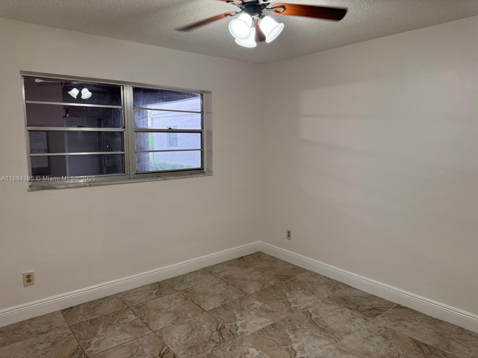 2471 Southwest 82nd Avenue, Unit 108 Davie, FL 33324 - Photo 12 of 14 an empty room with a empty space and window