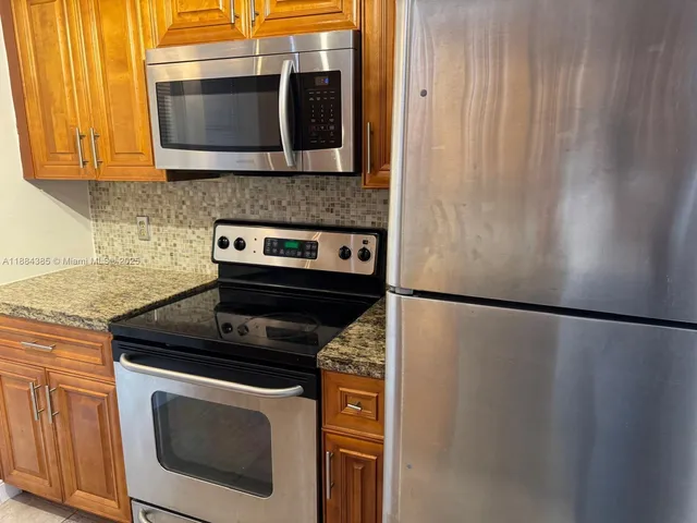 a kitchen with a stove microwave and refrigerator