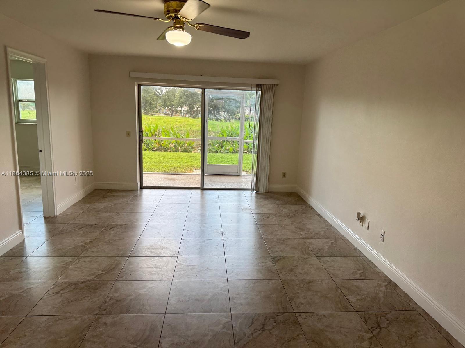 2471 Southwest 82nd Avenue, Unit 108 Davie, FL 33324 - Photo 6 of 14 a view of an empty room with a window