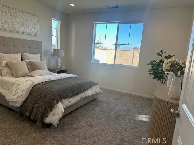 a bedroom with a bed and window